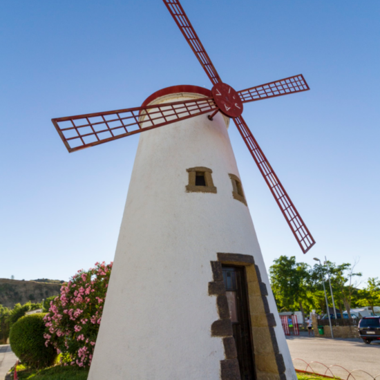 A white windmill with red blades, a landmark at the camping accommodation for the Running of the Bulls in Pamplona
