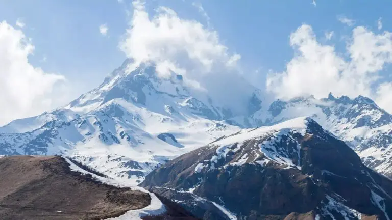Snow-covered Caucasus peak above a ridge road near Stepantsminda, Georgia