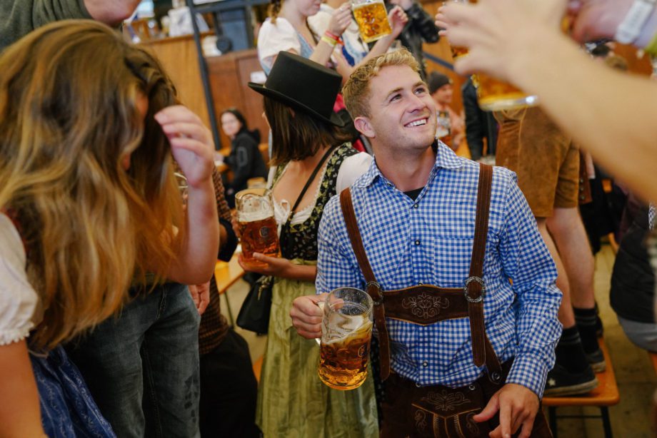 handsome man enjoys beer in beer hall at oktoberfest